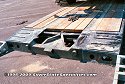 Once the gooseneck is detached, equipment can be loaded onto the lowboy. Check out the ramps to help <br>
				  the loader get up on top of the lowboy bed, and how much the loader's tires hang over the edge of the lowboy.<br>
				  Side extenders can be added/installed to widen the lowboy bed if necessary