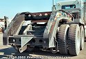 Here is a gooseneck attached to the truck tractor. Check out the center guide in the left foreground,<br>
				  which helps the truck driver align the gooseneck to the lowboy bed