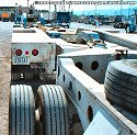 View from the rear of the heavy-haul lowboy unit. The very rear unit in foreground of photo<br>
				  is called a stinger, and pivots separately from the lowboy bed unit to assist in turning.  The stinger can also be<br>
				  removed if a load does not require its use