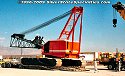 Crawler crane is on top of steel ramps now, so that the crane chassis is above the deck height<br>
				  of the lowboy trailer