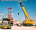 Once the crane chassis is resting on the lowboy bed unit, the crawler tread units can be removed<br>
				  from each side and will be loaded on separate flatbed trailers later