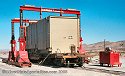 Transformer arrives via heavy-duty rail flatcar, and is being 
                    ready for unloading with Emmert's Gantries