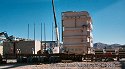 Transformer being moved off the heavy-duty rail flatcar and 
                    onto Emmert's heavy-duty dollies