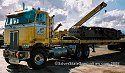 One of Jake's Peterbilt heavy-haul cabover tractors, with a flatbed trailer hauling a tread drive system from one of Jake's crawler crane units
