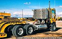 One of Jake's Peterbilt heavy-haul cabover tractors, with a lowboy trailer hauling a weight unit from one of Jake's crawler cranes