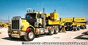 One of Jake's Peterbilt heavy-haul tractors, with special-purpose heavy-haul trailer<br>
				  complete with generators to drive the hydraulic controls