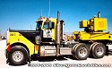 One of Jake's Peterbilt heavy-haul tractors, with special-purpose heavy-haul trailer<br>
				  complete with generators to drive the hydraulic controls