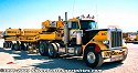 One of Jake's Peterbilt heavy-haul tractors, with special-purpose heavy-haul trailer<br>
				  complete with generators to drive the hydraulic controls