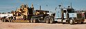 Peterbilt and heavy-duty lowboy setup transporting a Caterpillar D10N, as seen in Pan-Western's yard in mid-1990s