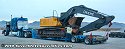 Removing chains and binders, as well as preparing to remove gooseneck portion of lowboy trailer