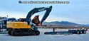 Driving excavator towards other lowboy trailer