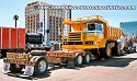 Peterbilt with Payhauler Dump Truck Loaded on Heavy-Duty Lowboy